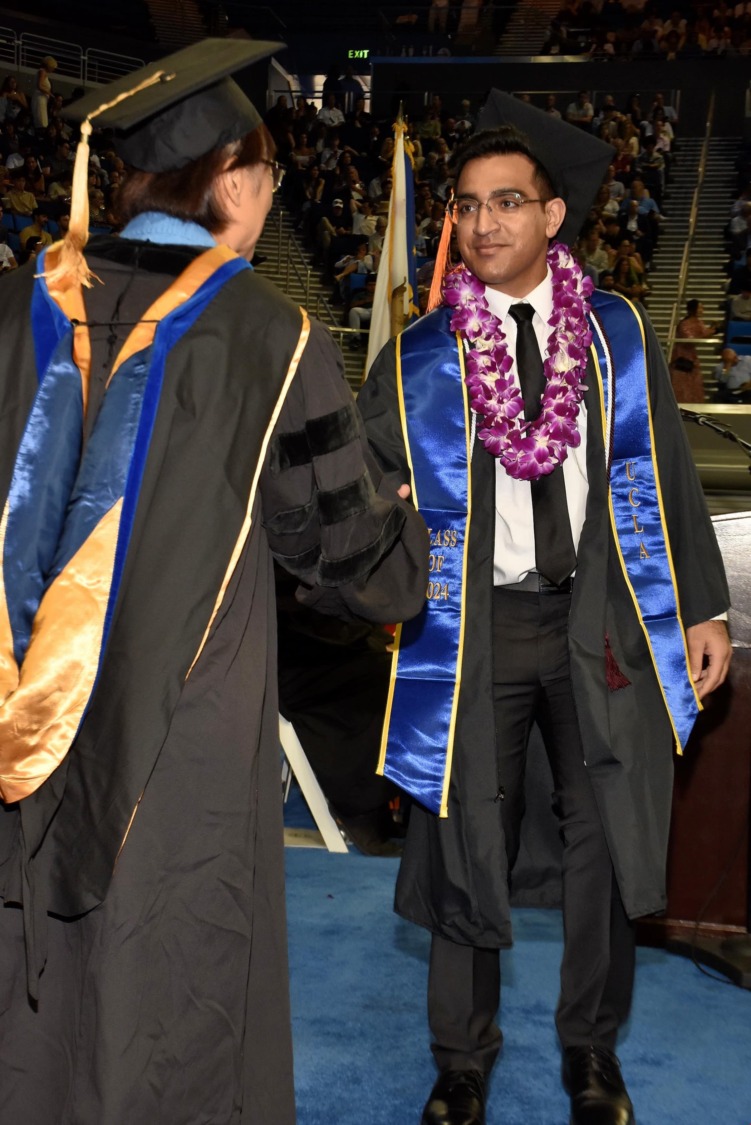 Photograph of me walking across the stage at graduation