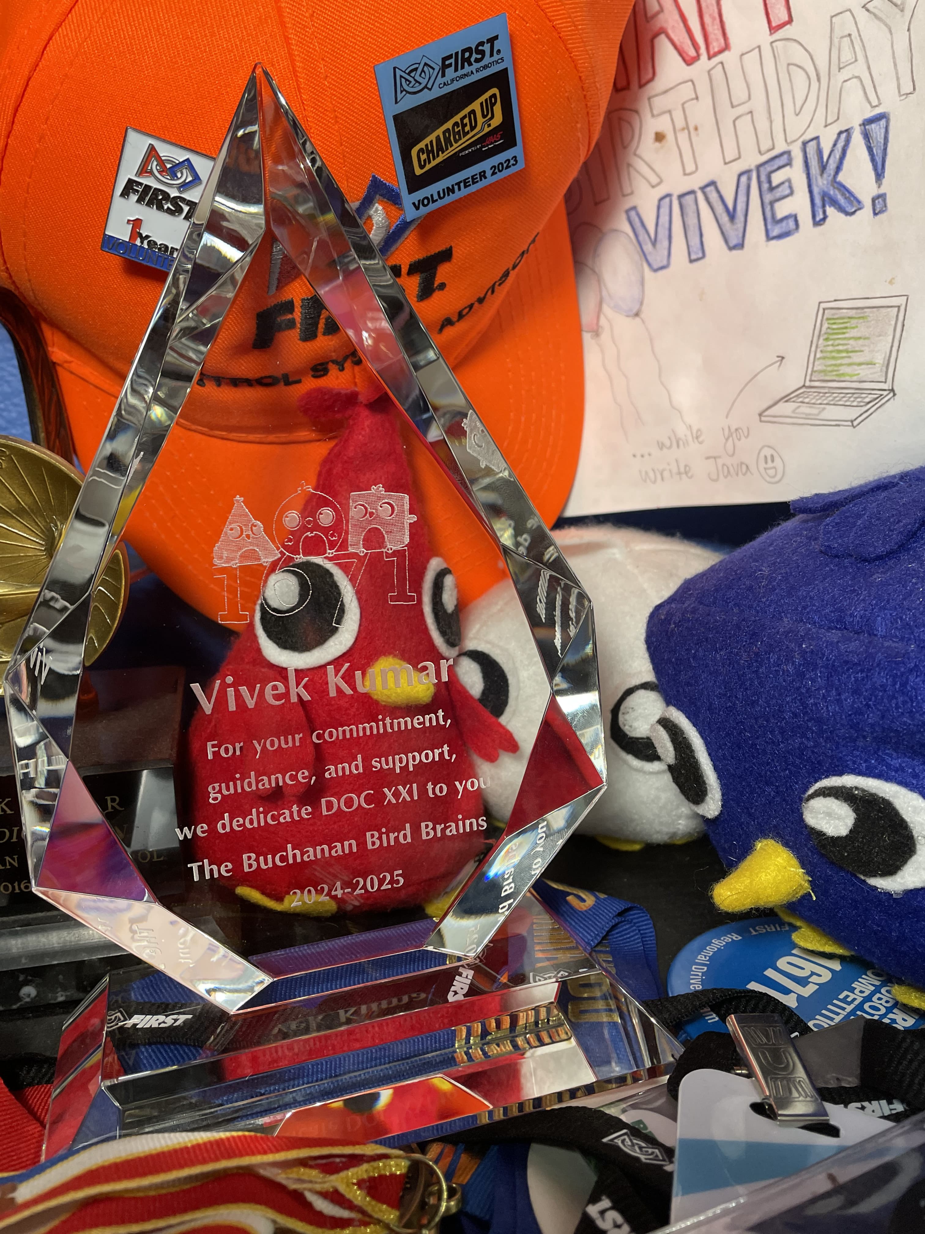 Image of robot dedication award. Text states "For your commitment, guidance, and support, we dedicate DOC XXI to you. The Buchanan Bird Brains. 2024-2025."